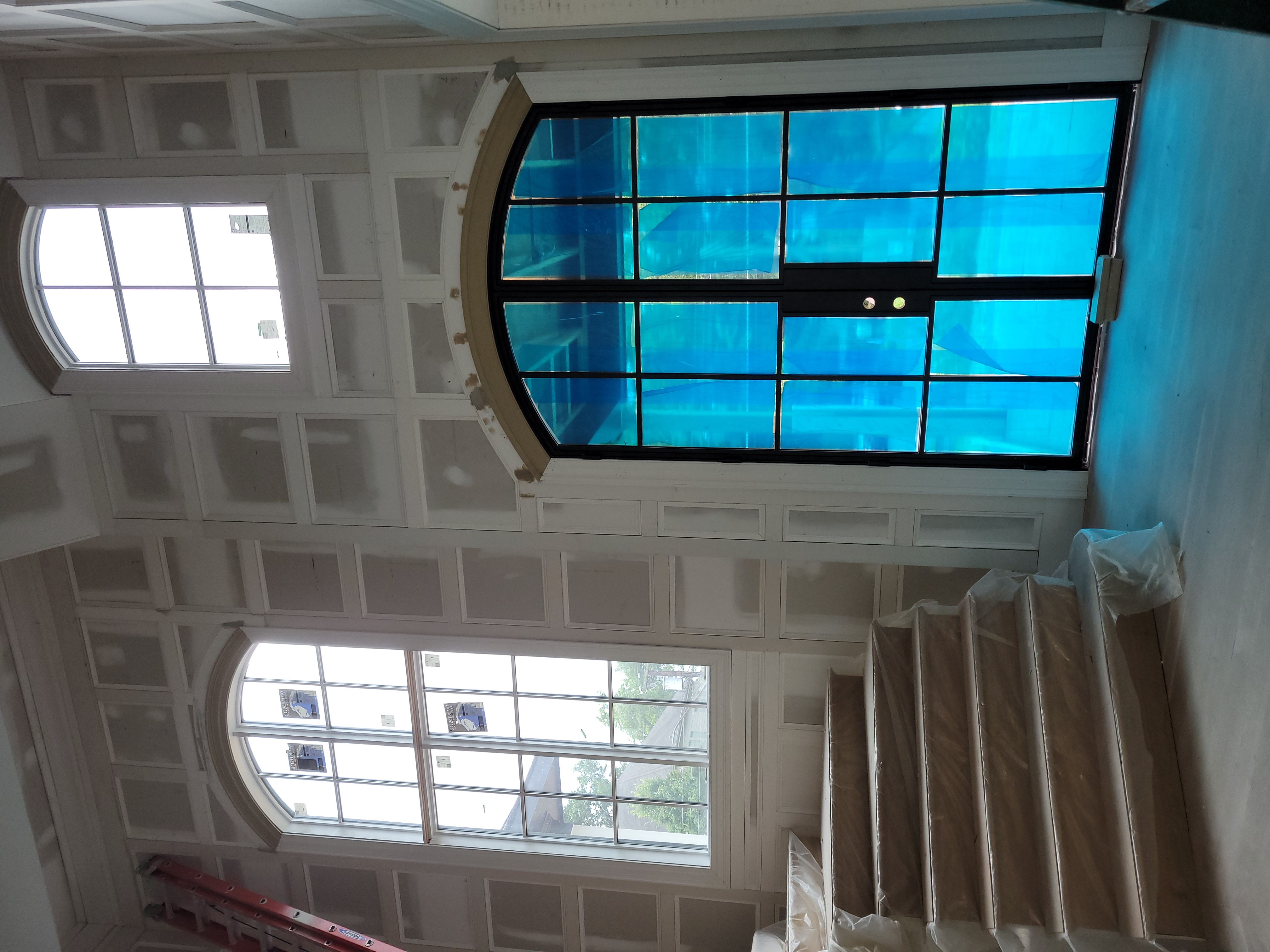 Two-story coffered wall panels with Palladian arch window