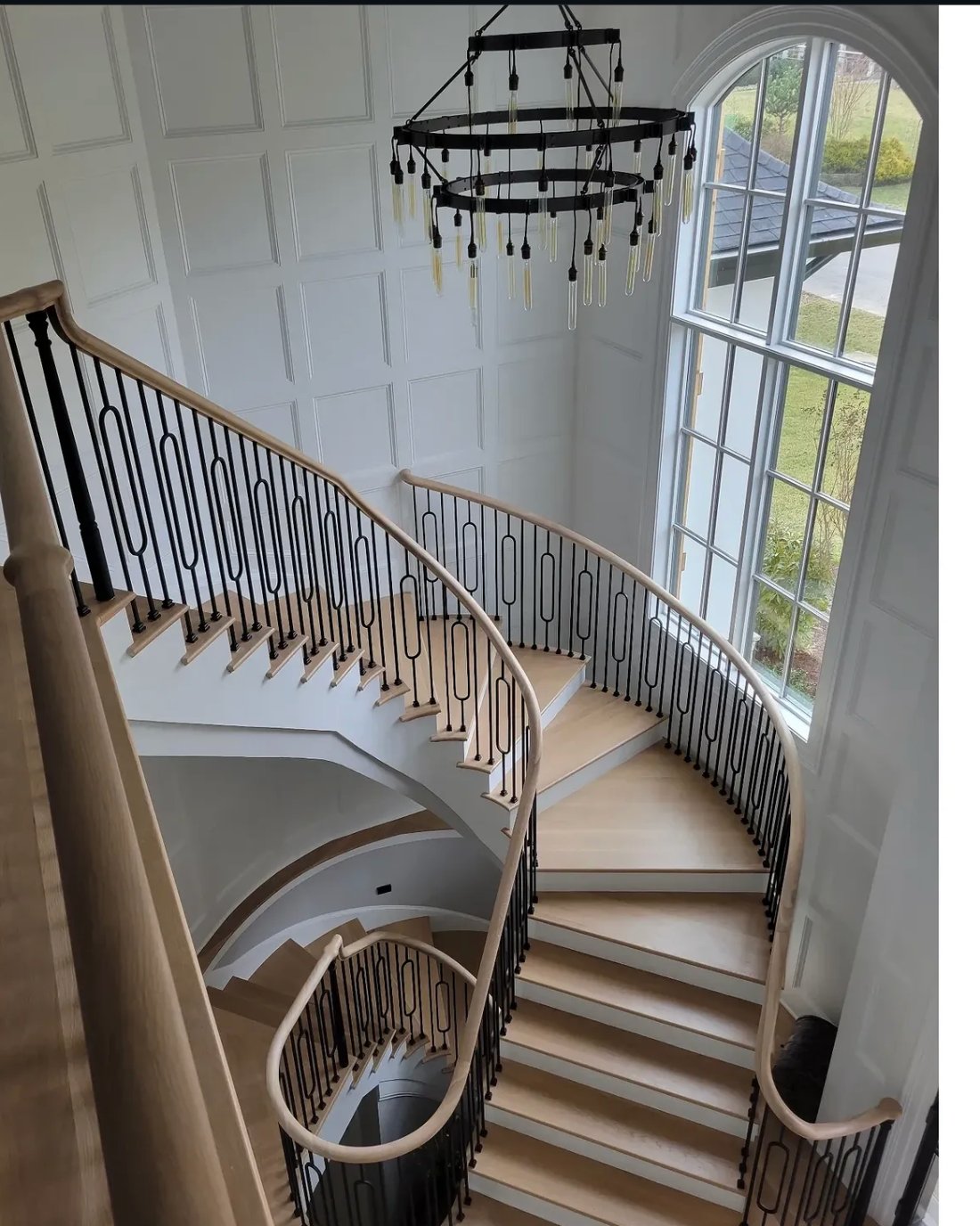 Curved staircase with custom ironwork